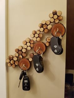 the keys are hanging on the wall with wood slices