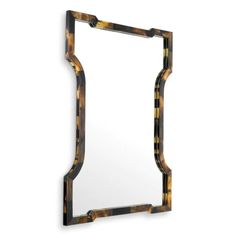 a mirror that is made out of tortoiseshells on a white wall