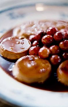 a white plate topped with donuts covered in sauce