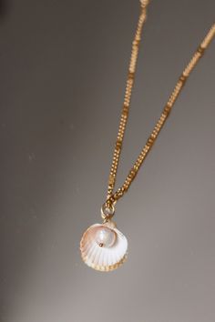 "A beautiful seashell form and a unique freshwater pearl. The brightness and shininess of the pearl makes this piece truly one of a kind!  This stunning necklace speaks to the uniqueness of each woman. With a bold, yet organic shape and a rich variety of real seashells, it will make you feel beautiful inside out. ♥ GIFT NOTE If you would like to include a short gift note during your order, we will be happy to add a short handwritten gift note to your order. Please let us know your message at che Mother Of Pearl Shell Necklace As Gift, Mother Of Pearl Shell Necklace For Gift, Ocean-inspired Mother Of Pearl Shell Necklace For Gift, Ocean-inspired Mother Of Pearl Shell Necklace As Gift, Ocean-inspired Mother Of Pearl Shell Necklace Gift, Pearl Pendant Shell Gift, Pearl Pendant Shell As Gift, Pearl White Shell With Pearl Charm, Pearl Shell With Pearl Charm