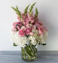 a vase filled with pink and white flowers