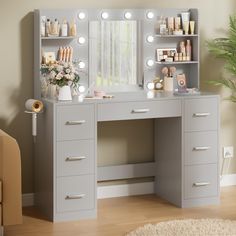 a gray vanity with lights on it and a mirror over the top that has drawers