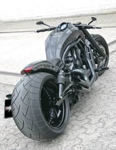 the motorcycle is parked on the side of the road with it's front tire