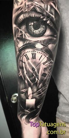 a man's arm with an eye and clock on it