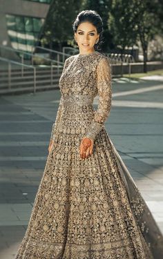 a woman in a long dress posing for the camera