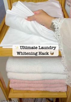 a stack of folded towels with the words ultimate laundry whitening hack written on it