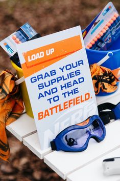 a sign that says grab your supplies and head to the battle field with goggles on it