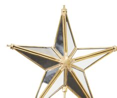 a gold and white star ornament hanging on a wall