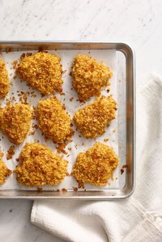 chicken nuggets on a baking sheet ready to be baked in the oven for dinner