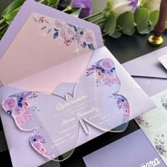 a purple and pink butterfly themed wedding suite with matching envelopes, cards and flowers