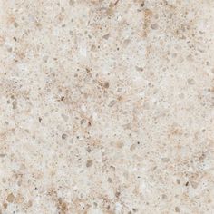 a close up view of a white marble counter top with brown speckles on it