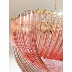 a large pink glass chandelier hanging from a ceiling