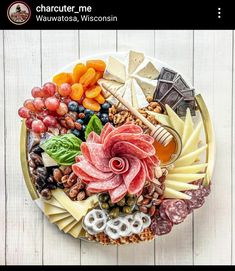 a platter filled with different types of cheese and meats