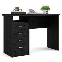 an office desk with drawers and a book on the top, next to a potted plant