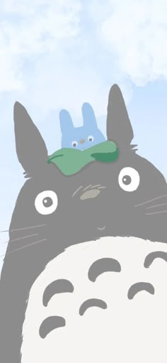 a totoro and another animal are on top of each other's head