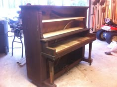 an old piano is being worked on in a garage