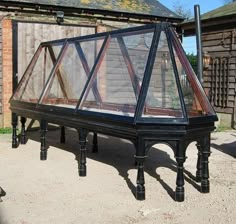 an old piano sitting outside in front of a brick building with glass on the top