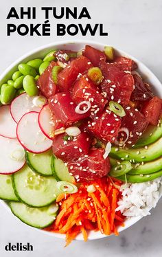 a bowl filled with lots of different types of food on top of a white table