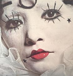 a close up of a person with makeup on and stars painted on their foreheads