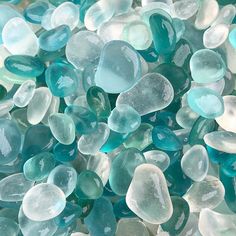 blue and white glass pebbles are piled together