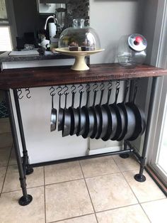 a kitchen counter with pots and pans hanging from it