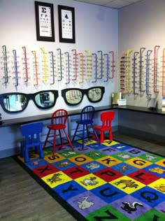 an eyeglass store with colorful rugs and chairs in front of the glasses on the wall