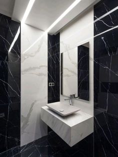 a bathroom with black and white marble walls