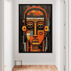 a painting hanging on the wall in a room with wooden flooring and white walls