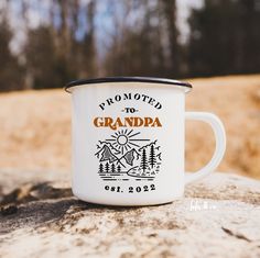 a white coffee mug sitting on top of a rock