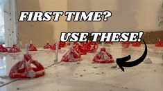 a group of red plastic cones sitting on top of a white floor next to a mirror