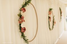 the wall is decorated with flowers and greenery