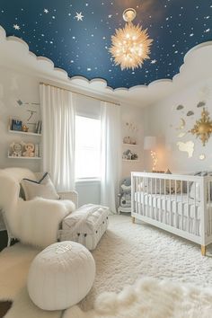 a baby's room decorated in white and blue with stars on the ceiling