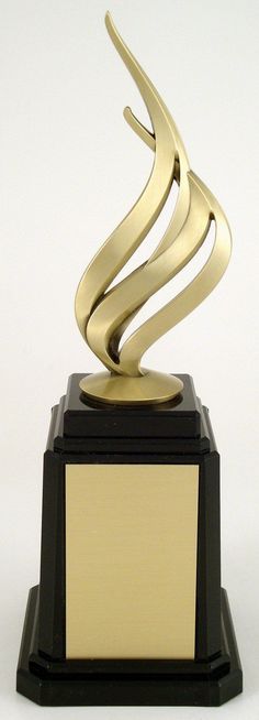 a gold and black trophy sitting on top of a table