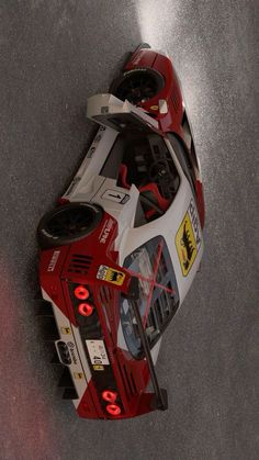 a red and white race car is shown from above