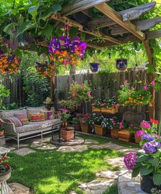 a garden with lots of potted plants and flowers hanging from the pergolated roof