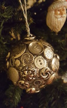 an ornament hanging from a christmas tree with other ornaments in the back ground