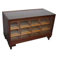 a wooden display case with many compartments