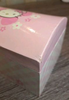 a hello kitty box sitting on top of a wooden table