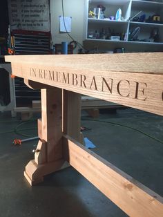 a wooden bench with the word remembrance on it