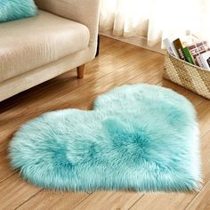 a blue heart shaped rug sitting on top of a wooden floor