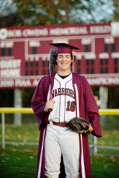 a man in a maroon and white baseball uniform is holding a bat, glove and ball