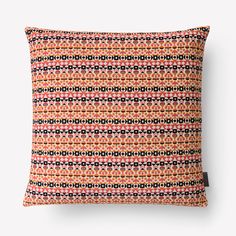 an orange and black pillow on a white background