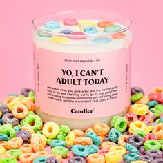 a candle that is sitting on some kind of candy corn kernels and it says yo i can't adult today