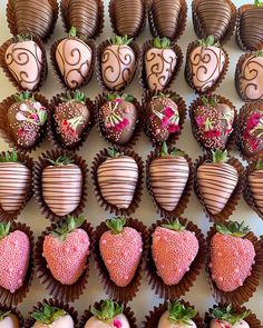 chocolate covered strawberries are arranged in rows on a white surface with pink flowers and swirls