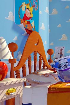 a child's bedroom decorated in blue and orange with cartoon characters on the wall