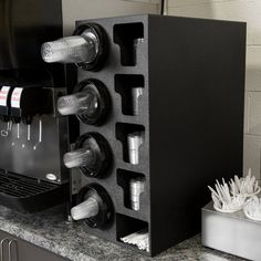 an espresso machine sitting on top of a counter next to a cup holder