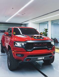 a red ram truck parked in a garage