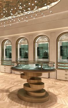 the inside of a jewelry store with multiple circular display cases and round tables in front of them