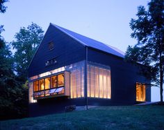 the house is lit up at night with bright windows