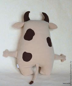 a stuffed cow laying on its back with it's legs spread out and eyes closed